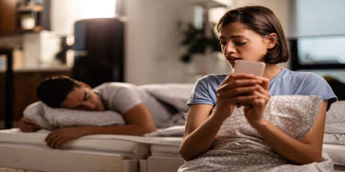 Young woman is secretly sending text messages