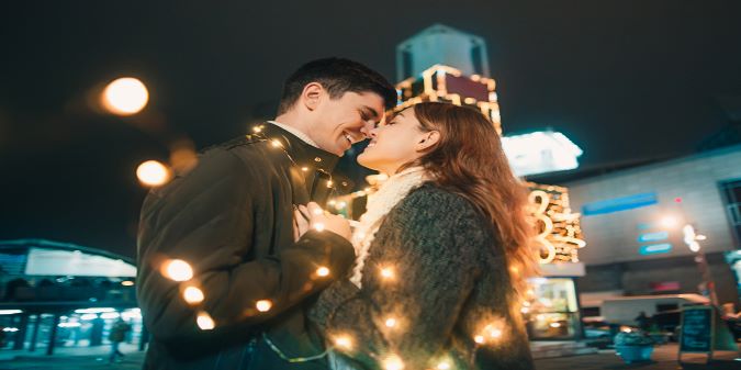 young couple kissing and hugging at christmas time